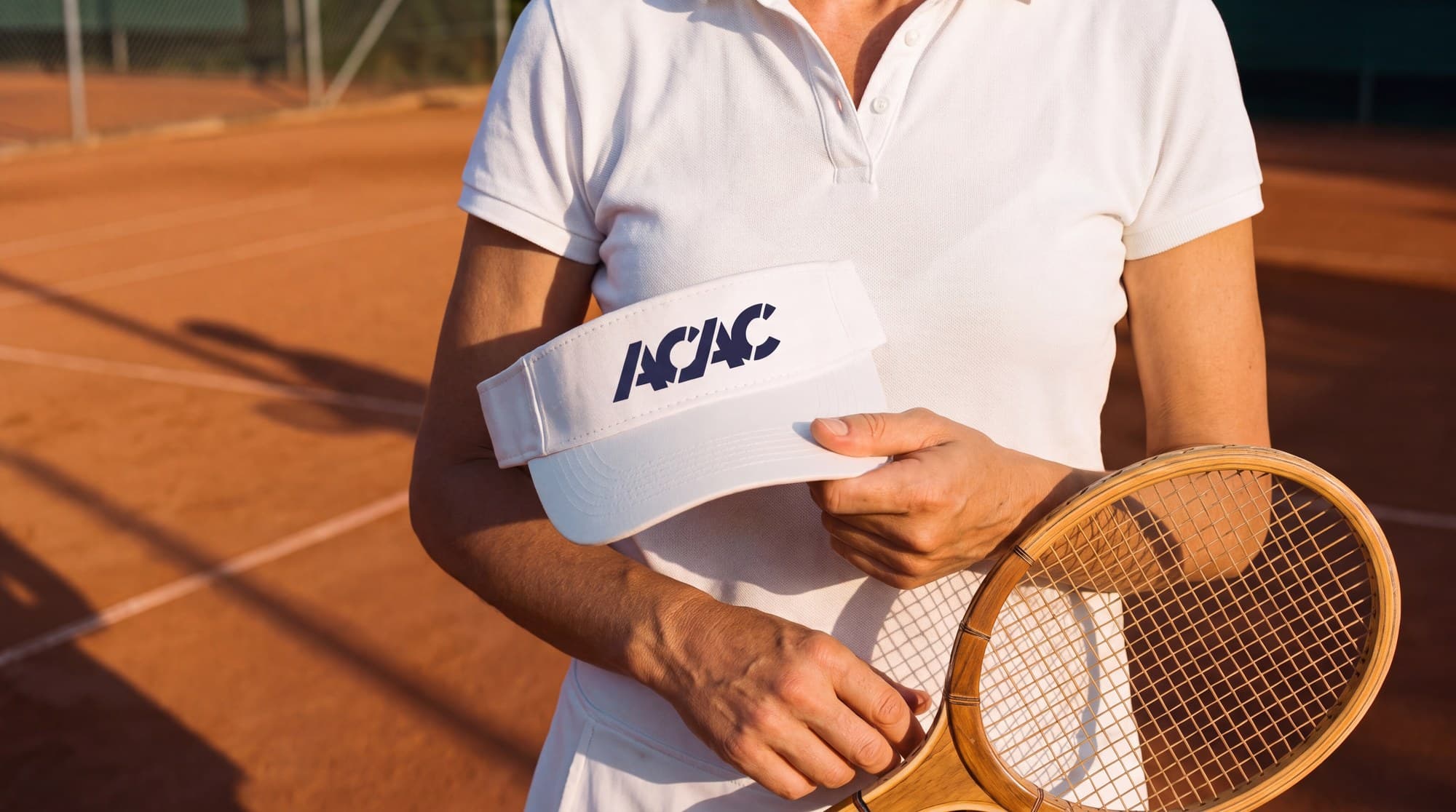An acac member with an acac visor on the clay courts